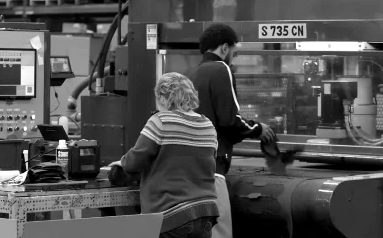 Two workers working in an assembly line